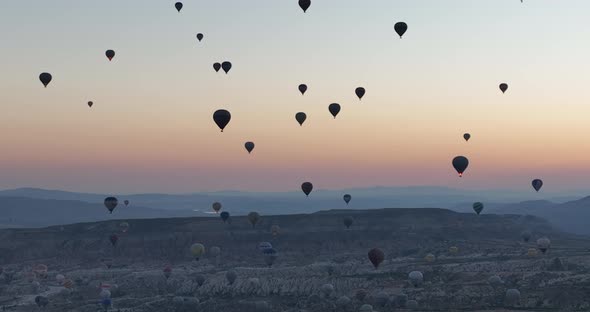 Aerial Cinematic Drone View of Colorful Hot Air Balloon Flying Over Cappadocia