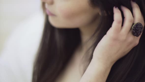 Close Up Portrait of Young Beautiful Woman Touching Her Brown Hair