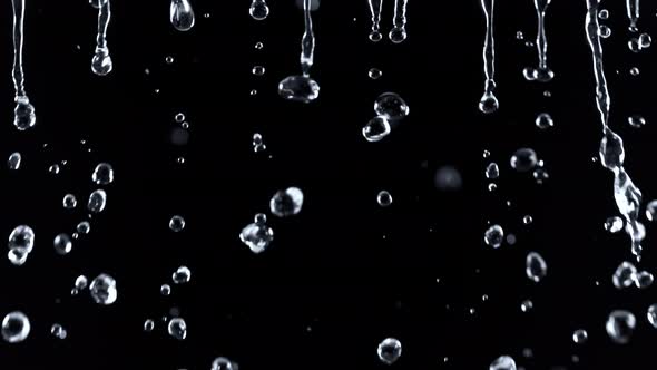 Super Slow Motion Shot of Falling Water Droplets Isolated on Black Background at 1000 Fps.