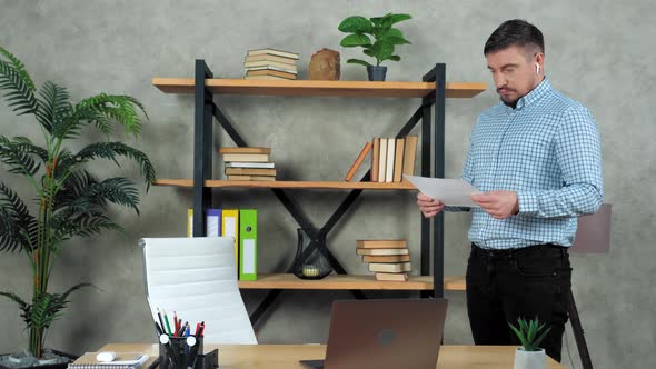 Businessman in home office with sheet of diagram in hand think solution problem
