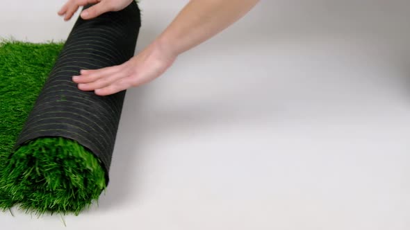 Roll of Artificial Green Grass on White Background