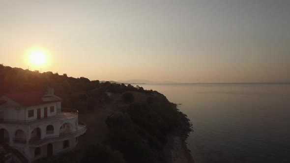 Aerial View of Sea, Waterfront Road and Upland Landscape at Sunset, Greece
