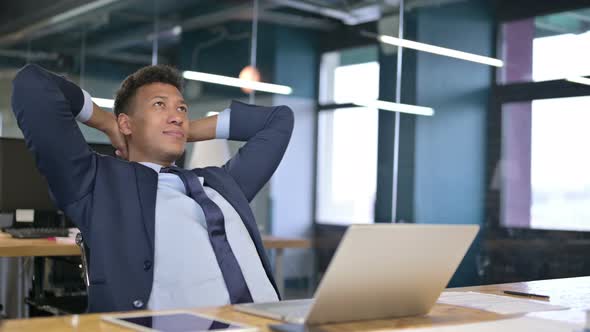 Serious Young Businessman Thinking in Modern Office 