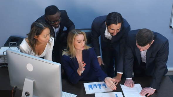 High angle view of creative team standing around table