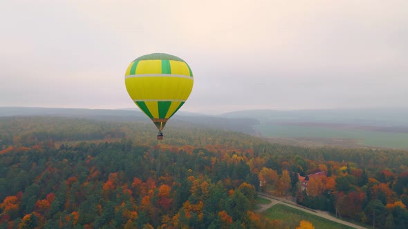 Balloon Flying Over the Autumn Forest in Thick Fog and Cloudy Weather View From Above