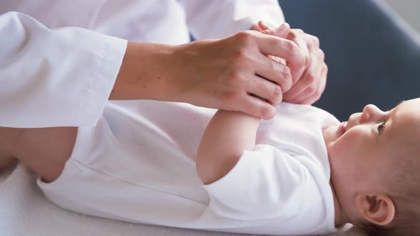 Female Pediatrician Doctor with Baby at Clinic