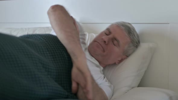 Middle Aged Man Trying To Sleep in Bed Alone