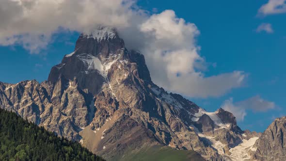 4K Moving Clouds Time Lapse Over The Single Snow Mountain Peak Ushba, The Georgia Nature Alps Matter