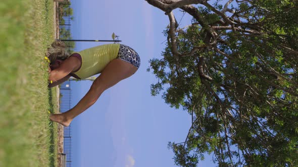 An Adult Woman Doing Yoga on Nature  Performing Sirosana Position