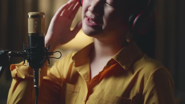 Close Up Young Asia Woman Singing In Recording Studio