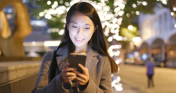 Woman use of cellphone at night