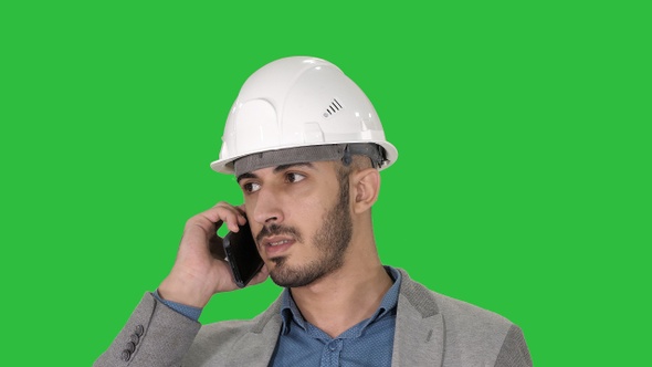 Engineer talking a mobile phone inspecting construction