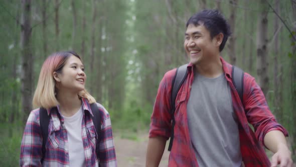 Hiker Asia backpacker couple adventure feeling freedom walking in forest, enjoy their holidays.