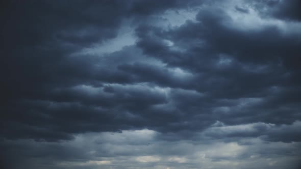 Dark heavy clouds in the sunset sky.