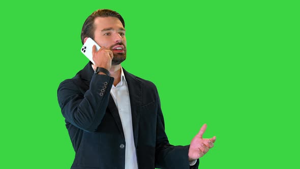 Cheerful Businessman Talking on the Phone on a Green Screen Chroma Key