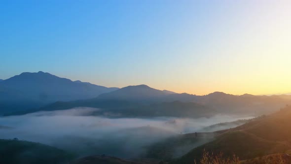 4K : Beautiful light of the dense fog and the sky at sunrise.