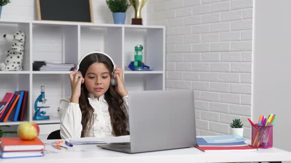 Worrying Child in Headphones Late on Online Lesson with Laptop Punctual