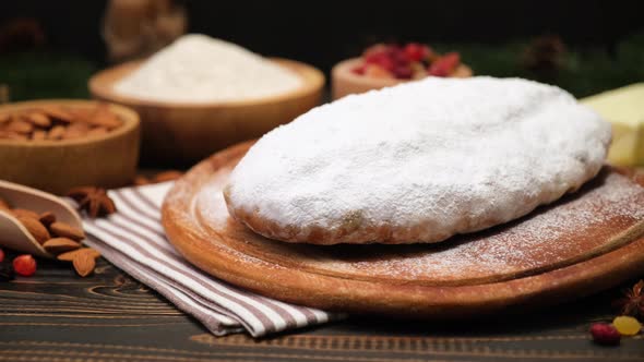 Traditional Christmas Stollen Cake Recipe with Ingredients on Wooden Background