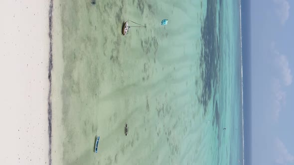 Vertical Video Kitesurfing Near the Shore of Zanzibar Tanzania Aerial View