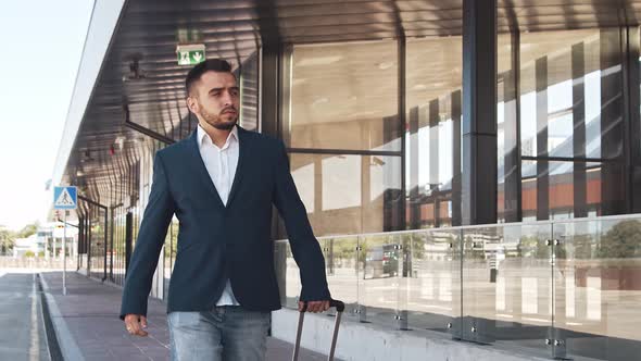 Elegant businessman in airport. Young mail entrepreneur in formalwear.