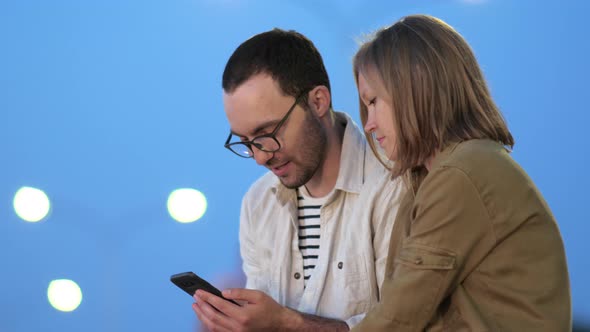 Smart Boy Showing Something on His Phone To His Girlfriend.