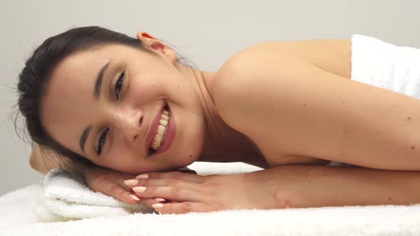 Girl Smiles on the Massage Table