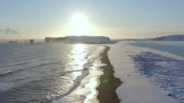 The Black Sand Beach at Sunset In Iceland Seen From The Air