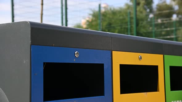 Little boy throws paper in waste container