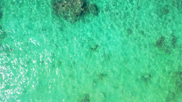 Aerial flying over sky of exotic coast beach holiday by blue water with white sand background of a p