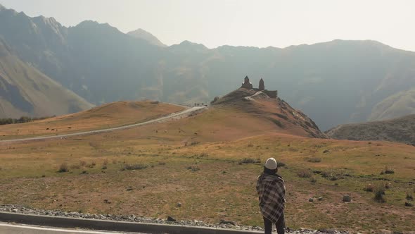 Tourist Looks To Gergeti Trinity Monastery, Slow Motion