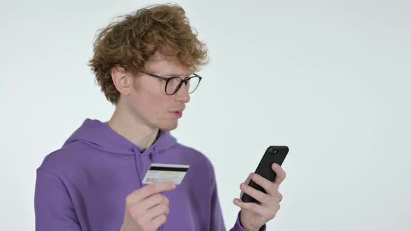 Online Shopping on Smartphone By Redhead Young Man White Background