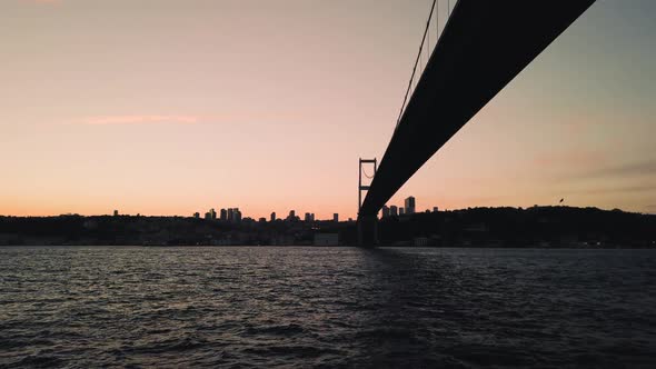 View of the Martyrs Bridge from a boating on the waters of the Bosphorus, against the background of