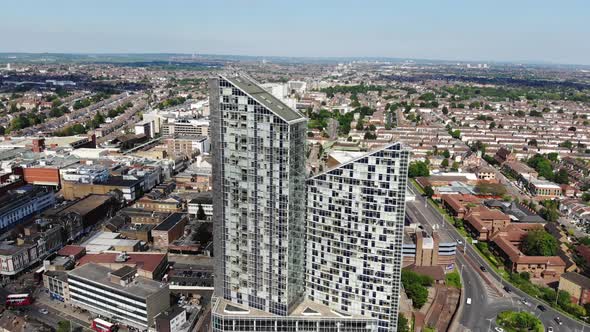 Aerial view rotating around the two tall buildings in Ilford, London on a sunny day