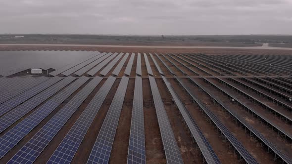 Aerial Drone View Into Large Solar Panels at a Solar Farm at Cloudy Autumn Day. Solar Cell Power