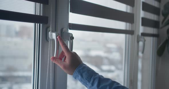 Man's Hand Closes the Window with a Lock on the Button