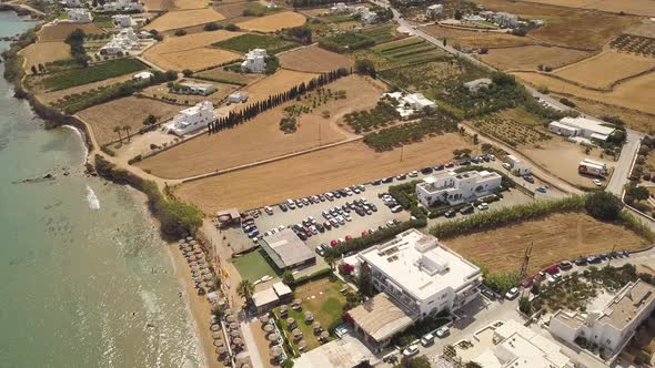 Establishing shot of a parking lot near a public beach on the greek island of Paros; Aegean Sea; ari