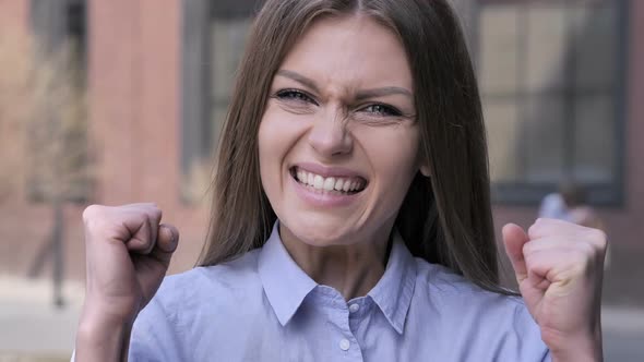 Young Woman Celebrating Success Outside Office