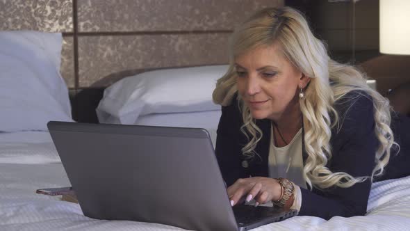 Beautiful Woman Looking for Information in Her Laptop