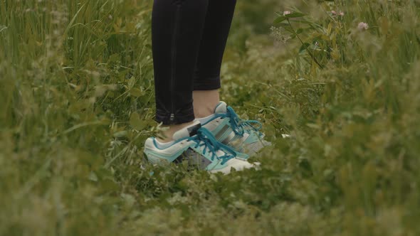 Woman Stretching And Warming-Up Before Running. Girl Limbering-Up And Stretching Legs And Hands.