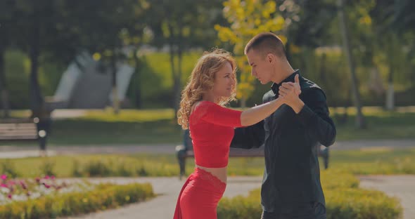 Workout of Professional Dancers with a City Park in Summer. Tango on the Street. Portrait View.