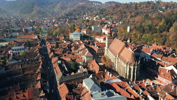 Aerial drone view of The Black Church in Brasov, Romania. Old city centre with buildings and yellowe