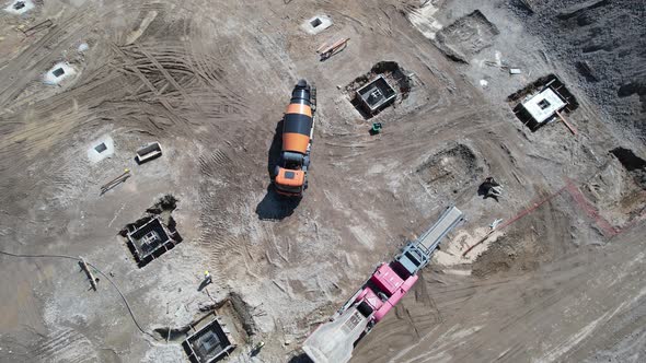 Construction Workers Working on a Building Site of New Residential Building