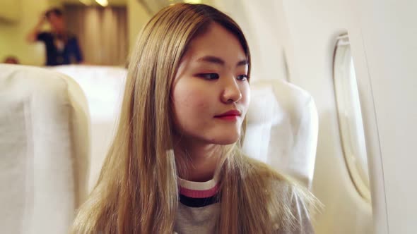 Happy Asian Woman Travel in Airplane