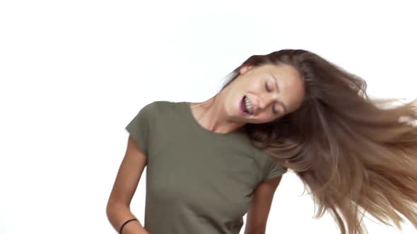 Adorable Girl in Grey Tshirt Having Fun Dancing with Her Long Luxurious Hair Fluttering in Motion