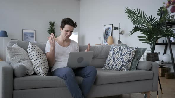 Upset Man Working on Laptop in Office