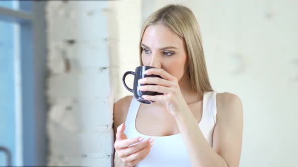 Medium Closeup Pensive Young European Woman Looking on Window at White Loft Interior