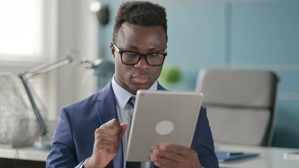 Portrait of Attractive African Man Using Tablet in Office