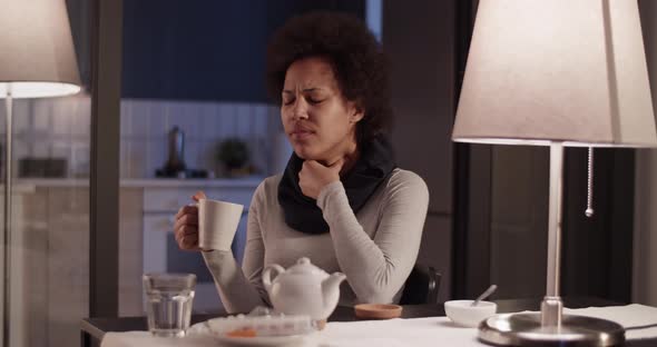 Woman with Sore Throat Drinking Tea