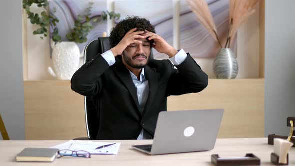 Irritated Arabian or Indian Businessman Ceo or Manager Sitting in a Modern Office Stressed