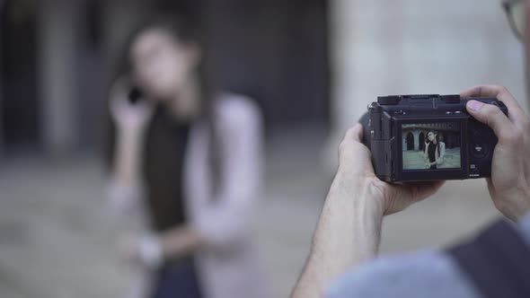 Female Model Talking In The Phone Posing At Photographer's Camera  Stolen Shot Concept